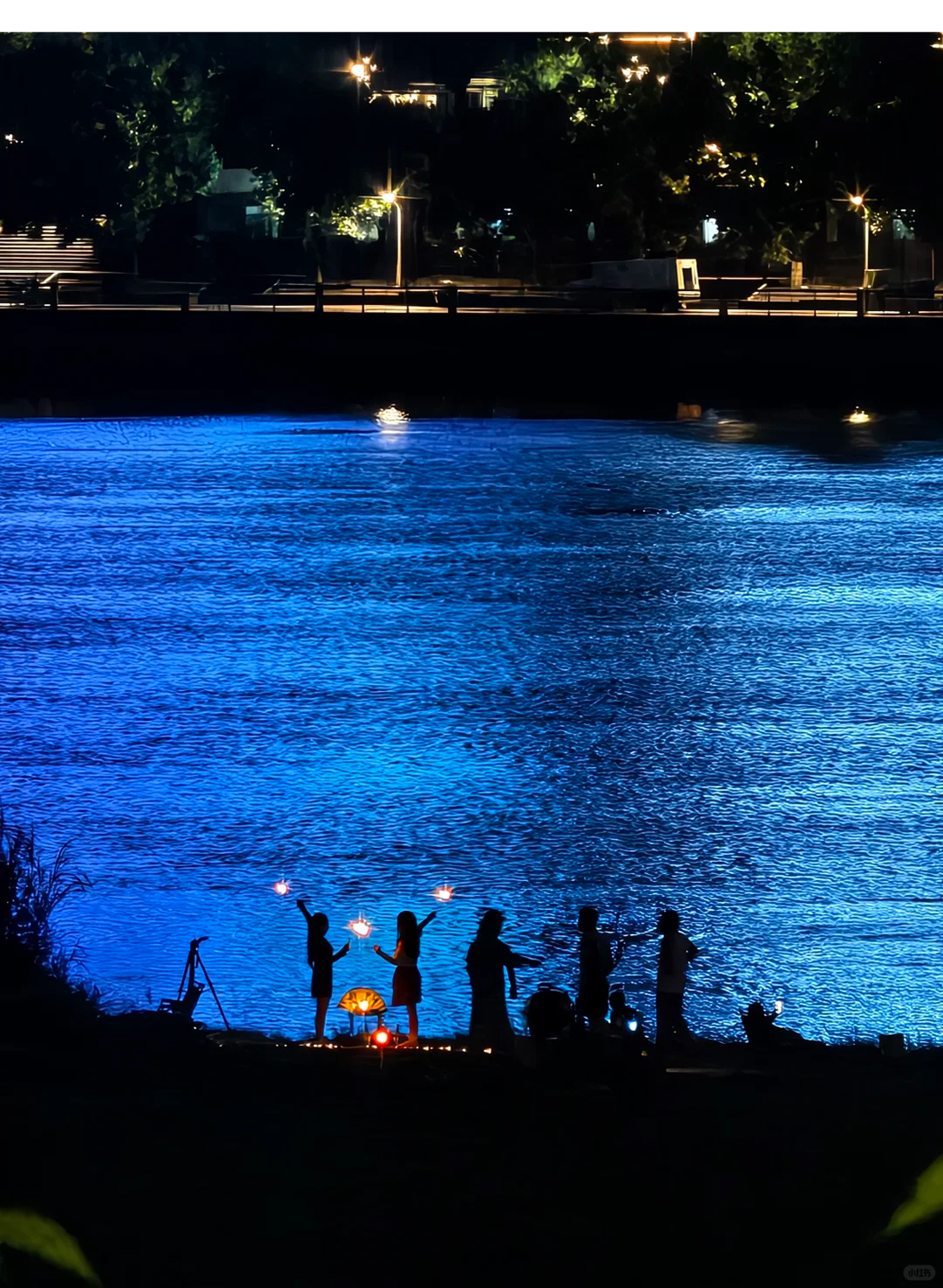Friends beside blue water